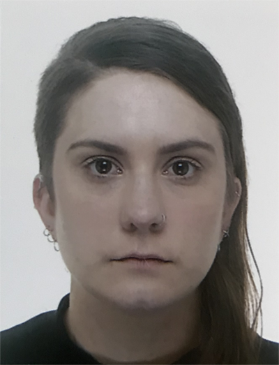 A headshot of the artist looking at the camera without smiling.