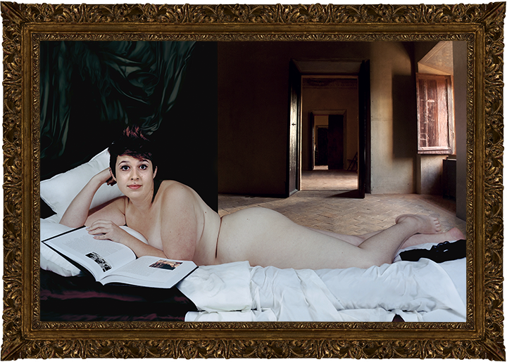 A woman lying on her stomach on a bed, reading an art history book. She has tan lines. A room is visible behind her. She is raising her eyebrows at the camera.
